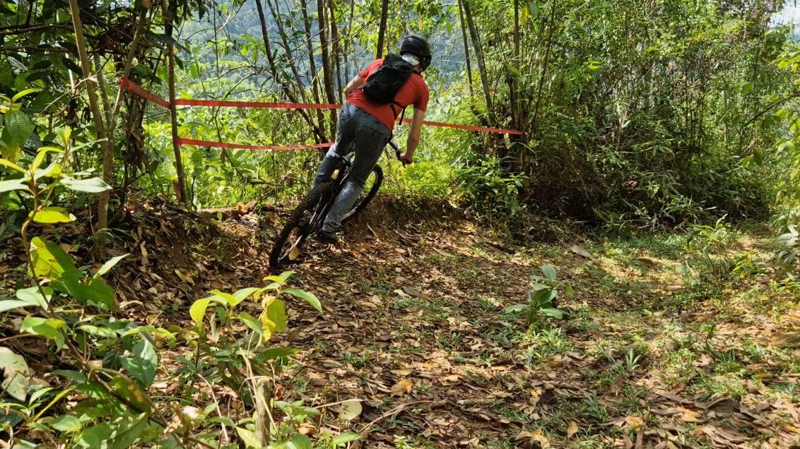A rider leans into a banked dirt corner